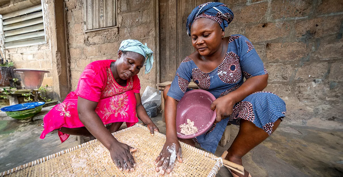 Emefa and Adjo sprinkle the sorghum flour with water and then roll it with their hands to form small pellets. Any pellets that are too small to be finished, granules of couscous fall through the sieve and are again rolled and sprinkled with dry sorghum and rolled into pellets.